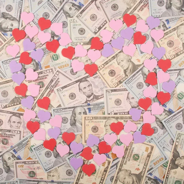 Heart symbol on money background.