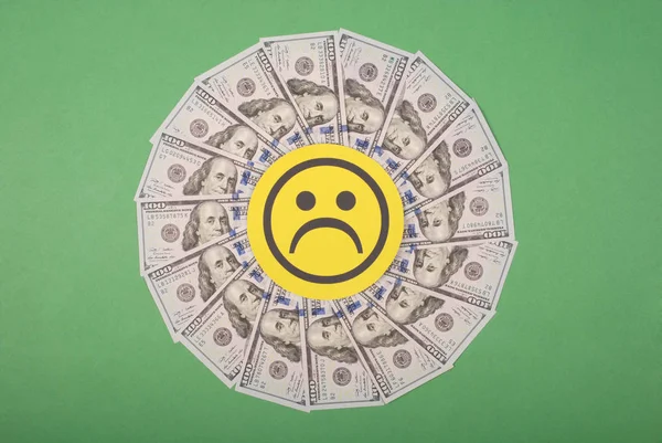 Sad smile faces on mandala kaleidoscope from money.