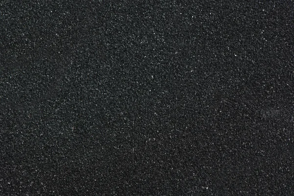 Macro photograph of sandpaper texture.Black sandpaper texture.Background of sandpaper. — Stock Photo, Image