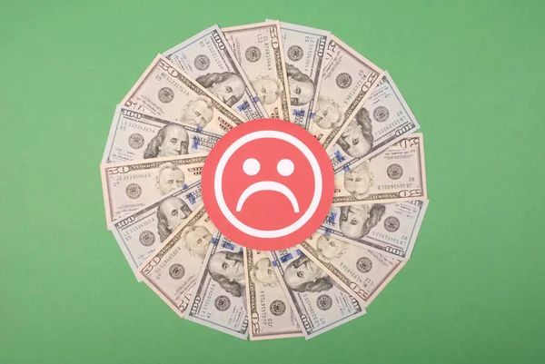 Sad smile faces on mandala kaleidoscope from money.