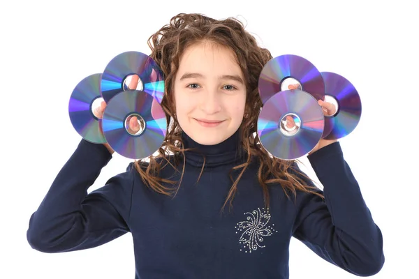 A young schoolgirl with curl hair holding cd or dvd. — Stock Photo, Image