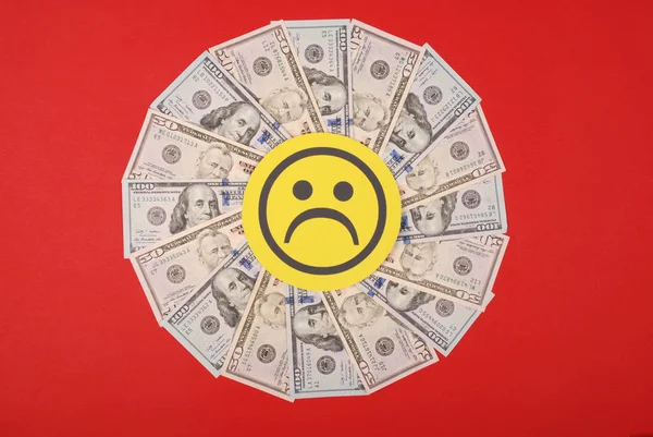 Sad smile faces on mandala kaleidoscope from money.