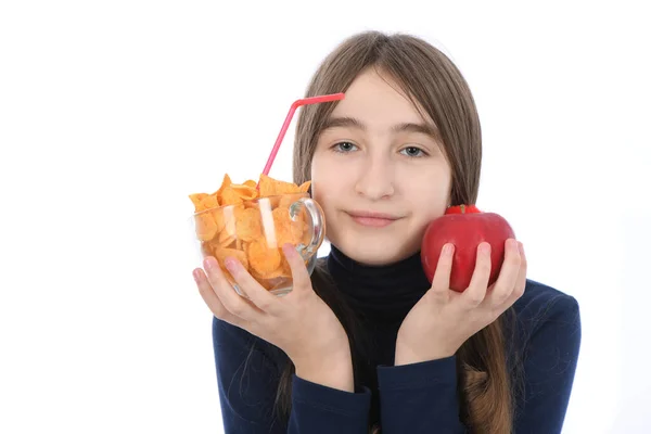 未成年の少女は ポテトチップスと赤いリンゴでいっぱいのボウルを量ります 白い背景に隔離されている 高解像度写真 フィールドの深さ 健康で不健康な食品の選択の概念 — ストック写真