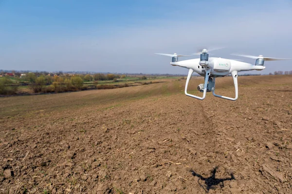 quadcopter drone over rural field, modern technology and nature