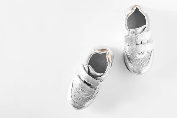 Flat Lay Silver Children Sports Shoes Isolated White Background — стоковое фото