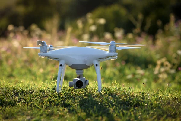 Close up on white drone camera. Drone quadcopter in flight
