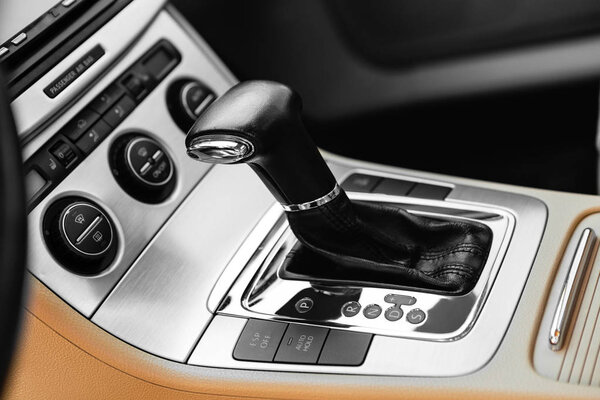 white automatic gear stick of a modern car, car interior details