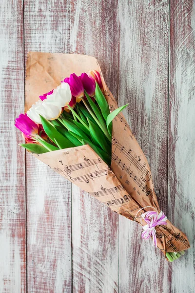 Bouquet Tulips Wrapped Paper Isolated Wood Background — Stock Photo, Image