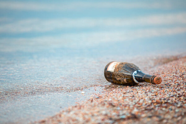 Green glass bottles were left on the beach.