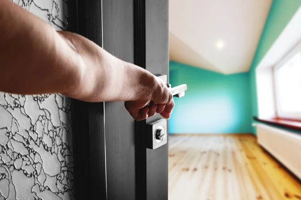 The woman's hand opens the black wood door — Stock Photo, Image