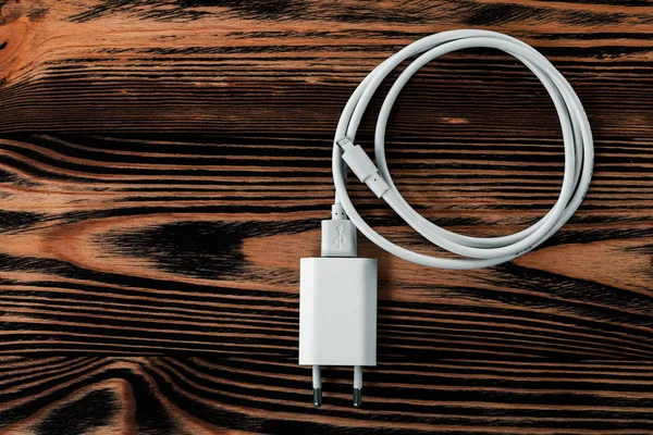 Cable phone chargers on wood background — Stock Photo, Image