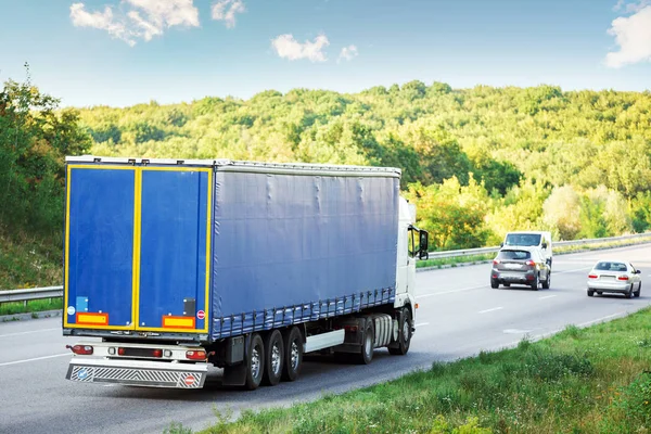 Anländer vit lastbil på vägen i ett lantligt landskap vid solnedgången — Stockfoto