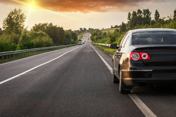 Black car on asphalt road — Stock Photo, Image