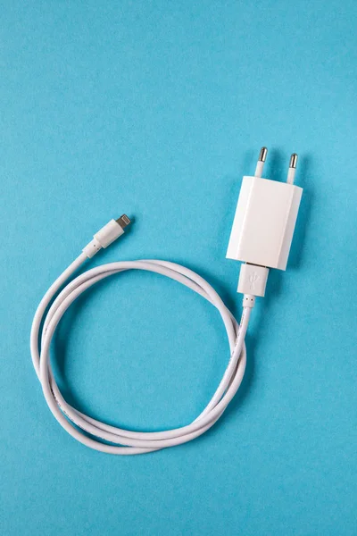 Cable phone chargers on blue background — Stock Photo, Image