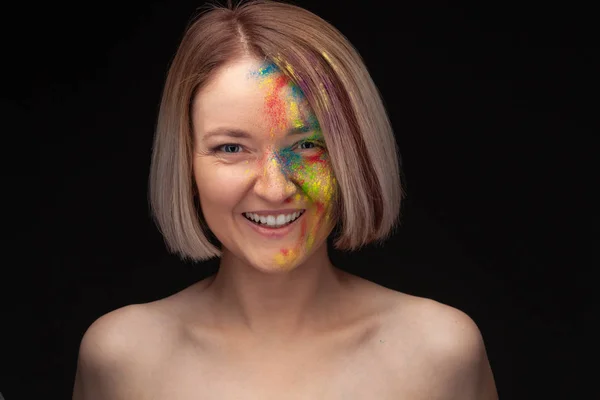 Studio portrait of young fashion model with bright colorful mix of paint. — Stock Photo, Image