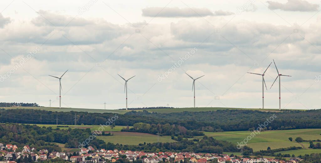 Wind power generators on a background of cloudy sky.