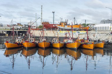 Orange fishing boats in Mar del Plata, Argentina clipart