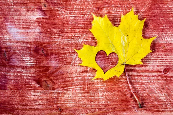 Yellow Maple Leaf Heart Shape Red Wooden Background — Stock Photo, Image