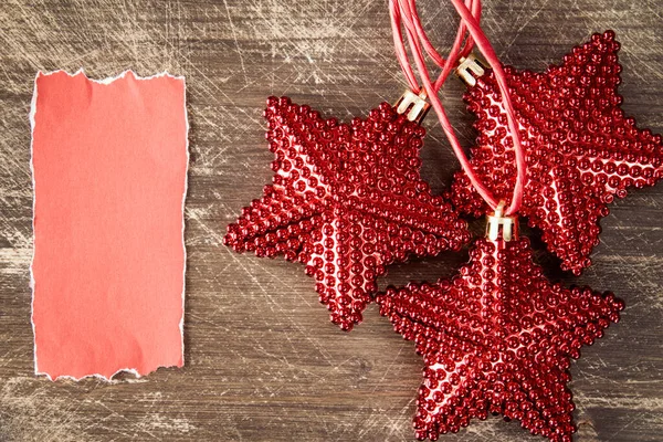 Étoiles Noël Rouges Avec Morceau Papier Blanc Pour Saluer Texte — Photo