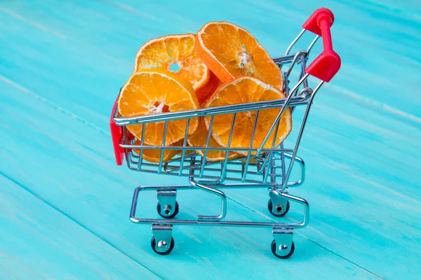 Dry Orange Shopping Cart Blue Wooden Kitchen Table Background — Stock Photo, Image