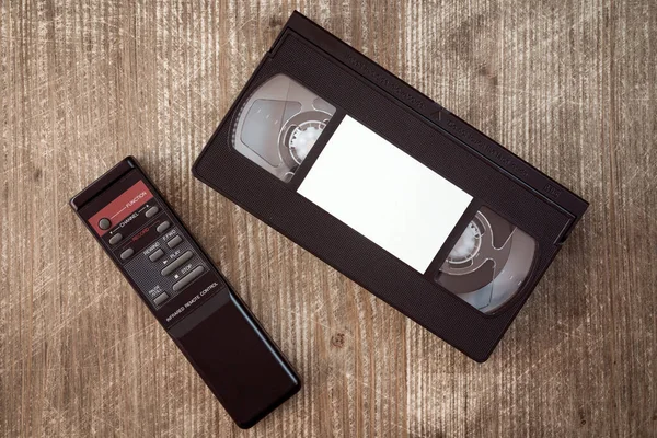 Vhs Video Tape Cassette Remote Control Wooden Background Copy Space — Stock Photo, Image