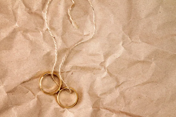 Two Gold Wedding Rings Tied String Paper Background — Stock Photo, Image