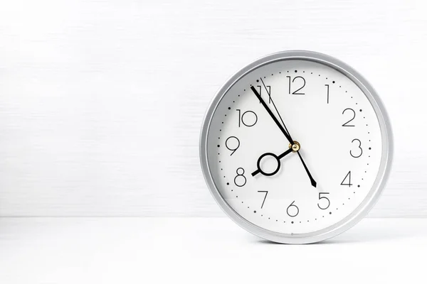 Zegar Ścienny Srebrny Białym Drewnianym Biurku Przestrzeń Kopiowania — Zdjęcie stockowe