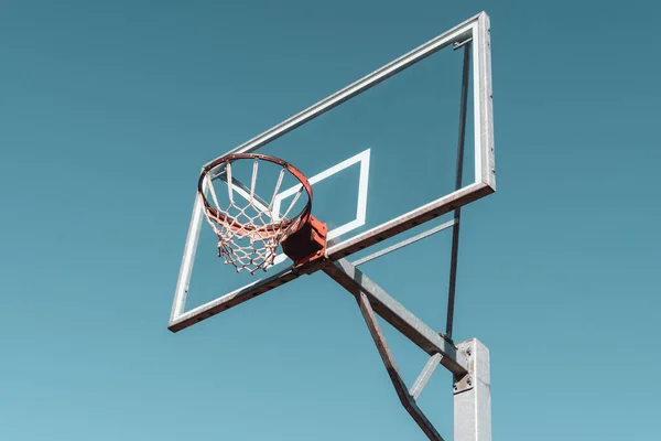 Basketball ring and board. Low angle view. Filtered image.