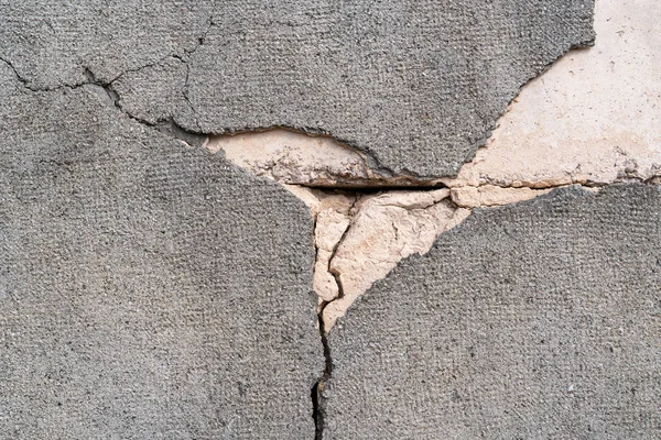 背景として灰色のセメント表面で覆われたコンクリート壁を割り — ストック写真
