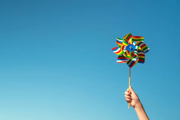 Child Holds Colorful Pinwheel Blue Sky Background — Stock Photo, Image