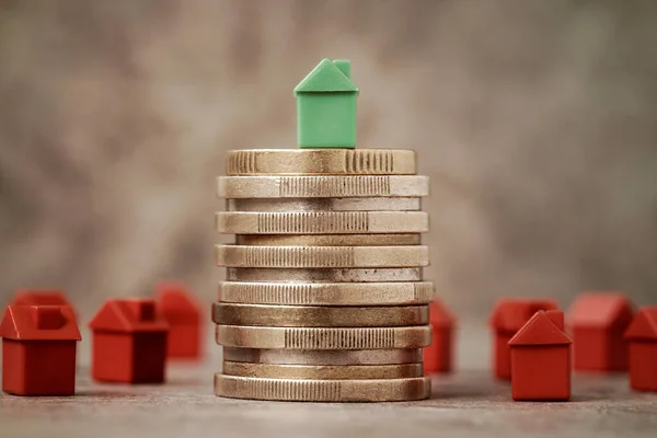 Property Investment or House Mortgage Finacial Concept, Mini House On Top Of Coin Stack