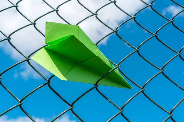 Zöld Papírrepülő Beragad Fém Kerítésbe — Stock Fotó