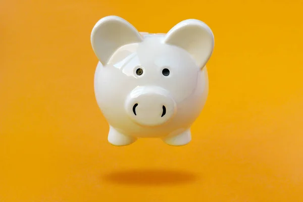 White Piggy Bank Leviterar Över Gul Bakgrund Finansiellt Koncept — Stockfoto