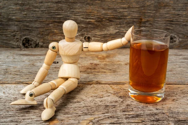Wooden man showing stop gesture and refusing to drink. Problem of alcoholism, man stop drinking more.