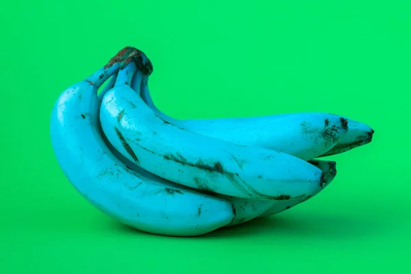 Genetically Modified Food Gmo Concept Blue Bananas Green Background — Stock Photo, Image