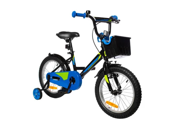 白色底座上有额外轮子的儿童自行车 免版税图库照片
