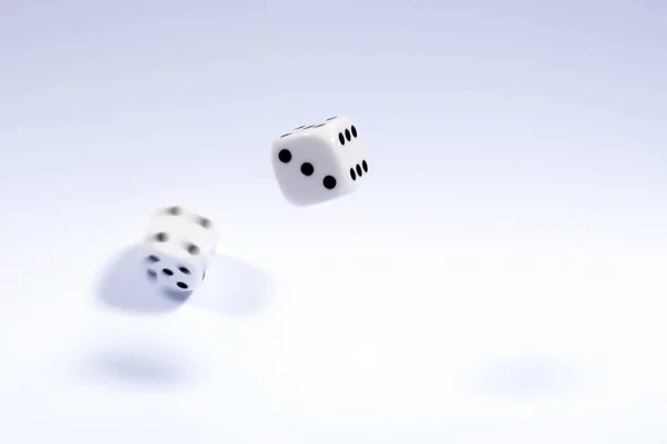 Shot of dice which have been thrown and randomly bouncing.