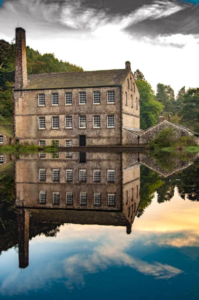 Reflection of an old mill in the mill pond