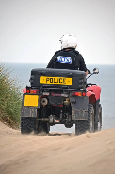 British police on the sand dunes of Formby, United Kingdom on Quad bikes