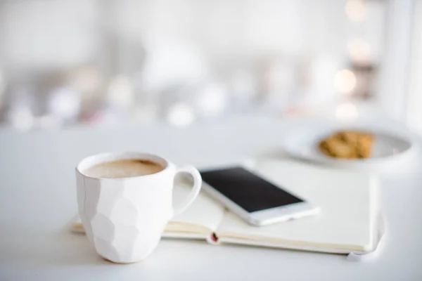 Modern white office, designer handmade cup of coffee, smartphone — Stock Photo, Image