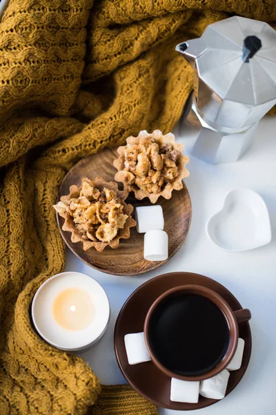 Warm home arrangement on windowsill, coffee and cookies with can