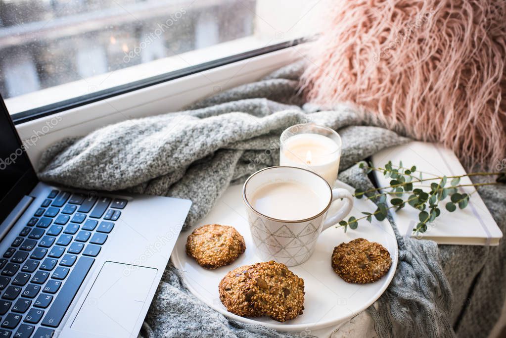 Cozy weekend breakfast with cup of coffee and cookies on ceramic tray