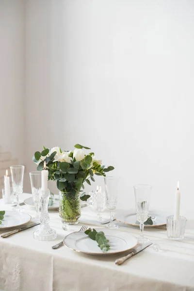Beautiful festive table setting with elegant white flowers and cutlery, dinner table decoration