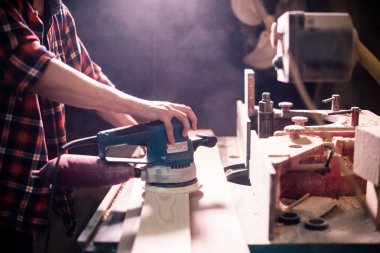 Genç yakışıklı doğrama onun marangozluk atölyesinde ahşap ile çalışan