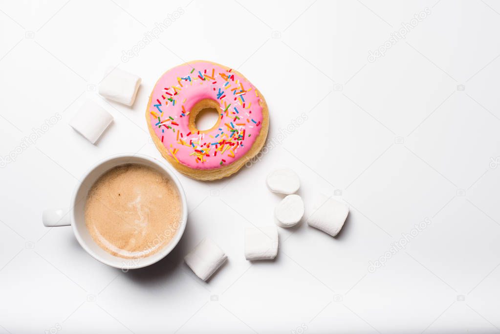Fresh hot coffe and pink sweet donut on white background isolated