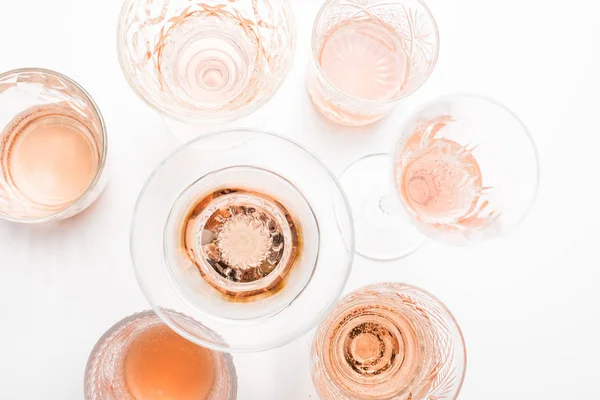 Sparkling rose wine in different glasses on white background — Stock Photo, Image