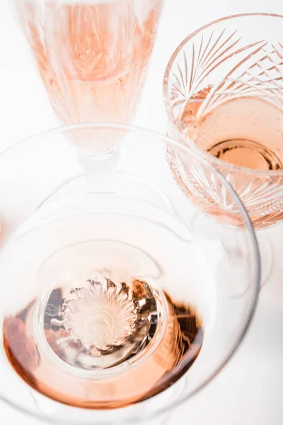 Sparkling rose wine in different glasses on white background — Stock Photo, Image