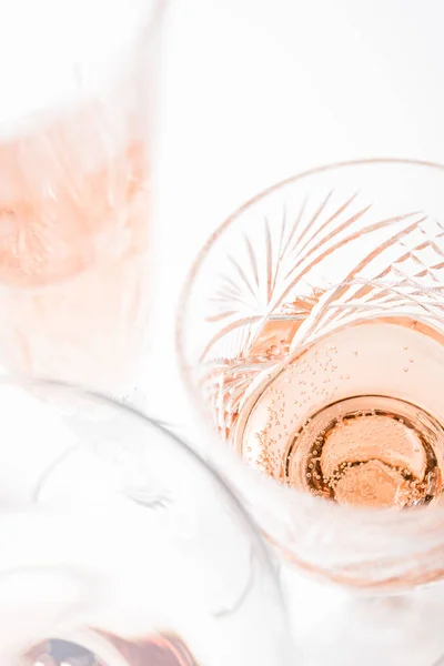 Sparkling rose wine in different glasses on white background — Stock Photo, Image