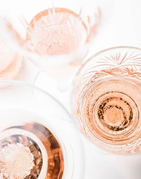 Sparkling rose wine in different glasses on white background — Stock Photo, Image