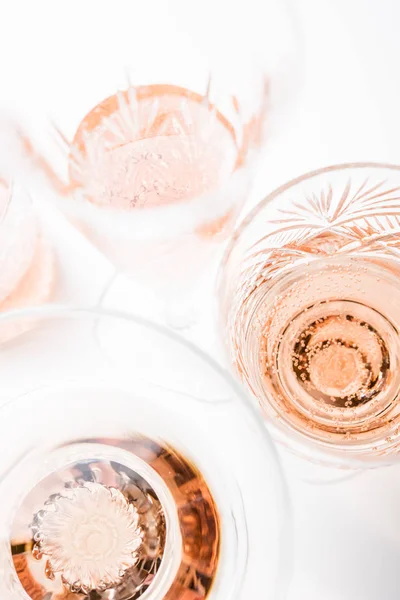 Sparkling rose wine in different glasses on white background — Stock Photo, Image